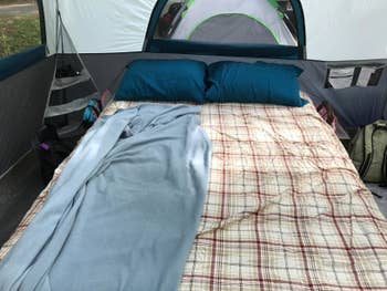 reviewer's cot in tent with sheets and pillows