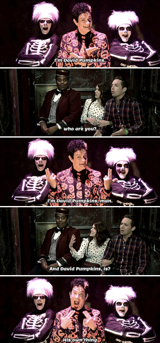 Tom Hanks as David S. Pumpkins, wearing a suit with pumpkins all over it, being hilariously spooky in a haunted elevator