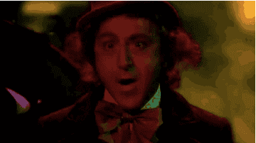 Willy Wonka making a scary face while the families scream and lights flash.