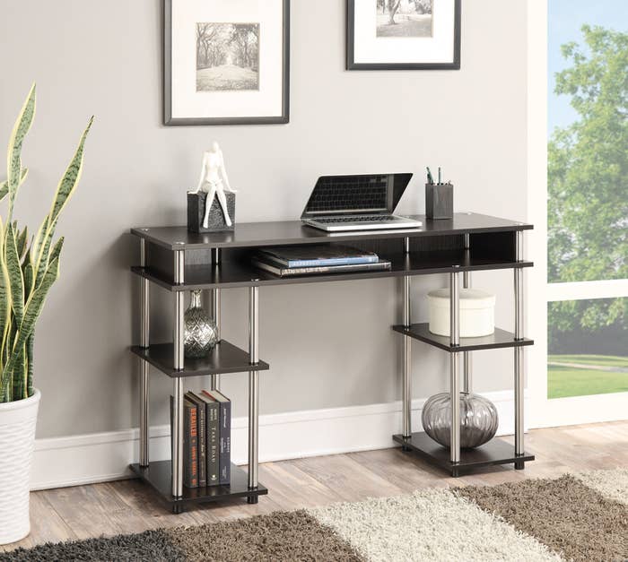 The black and silver desk with four open shelves
