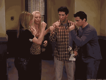 Phoebe, Rachel, Joey, and Ross from Friends playing rock, paper, scissors in their apartment hallway