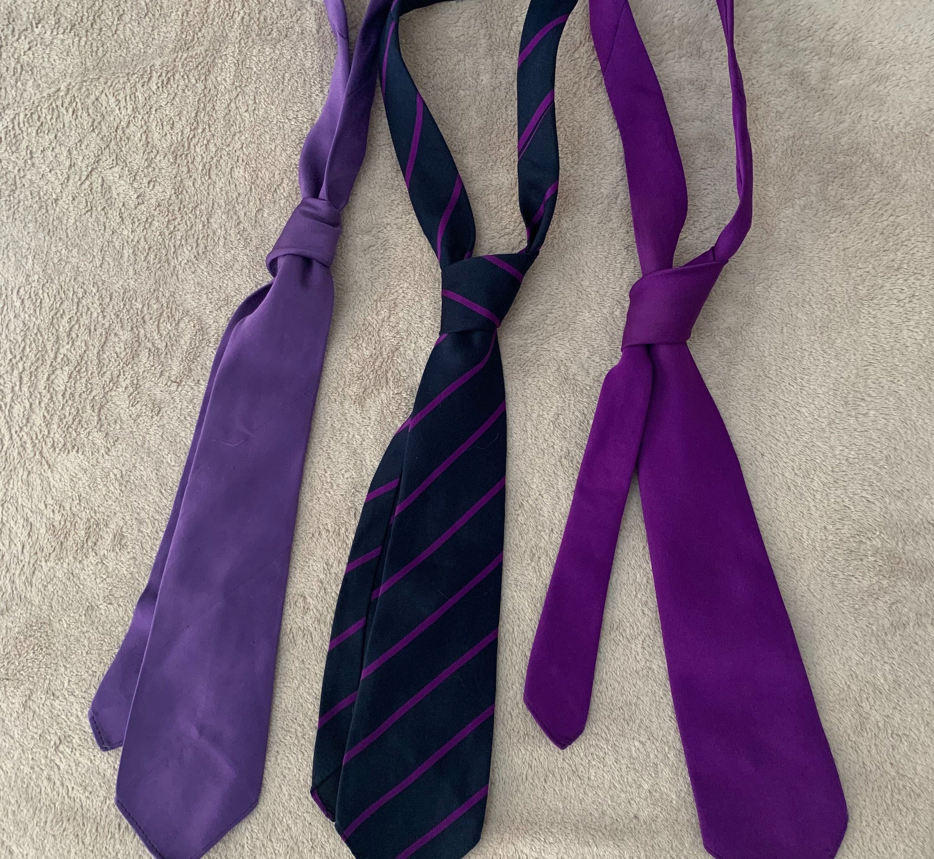 3 purple neck ties laid out