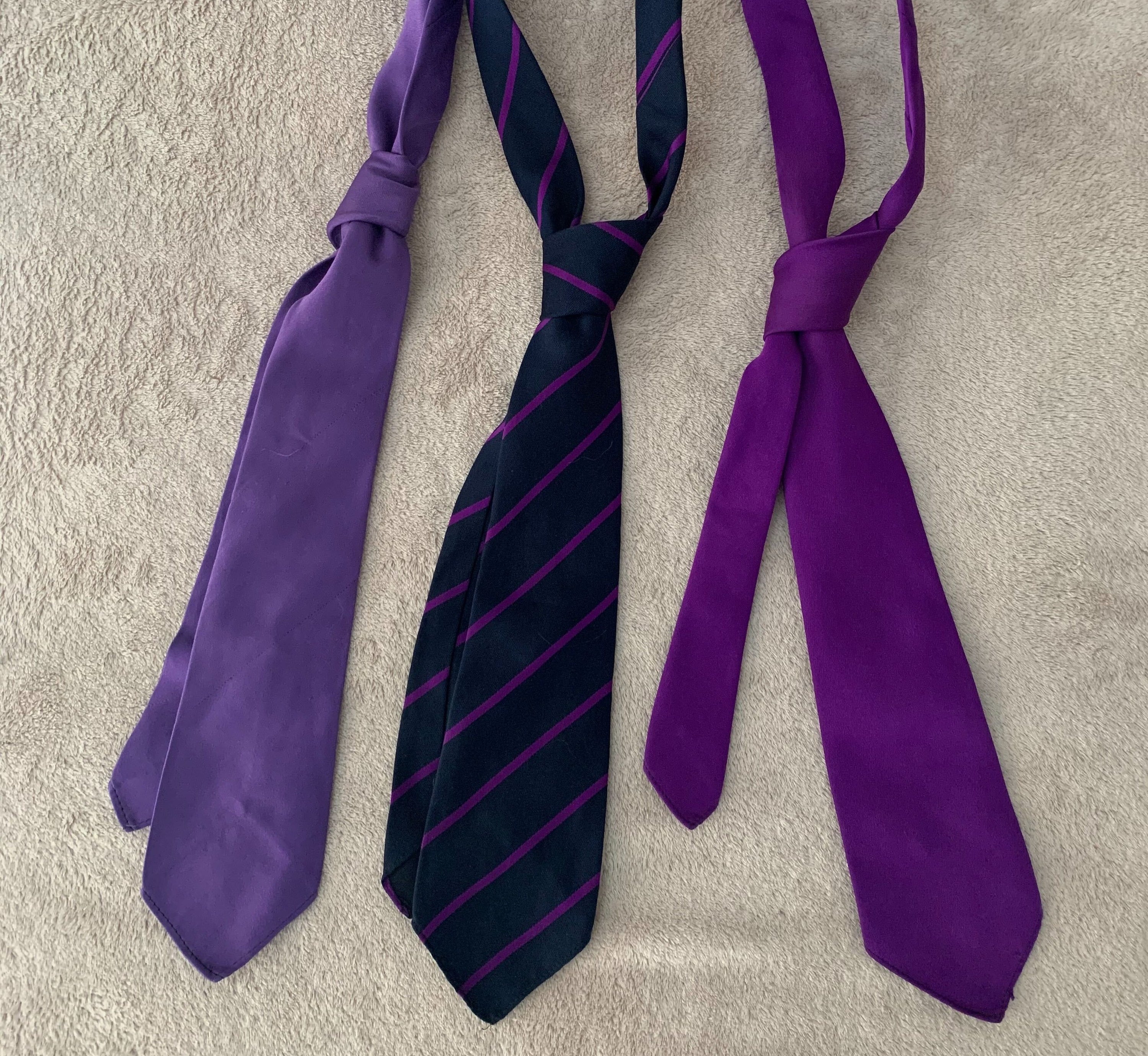 3 purple neck ties laid out