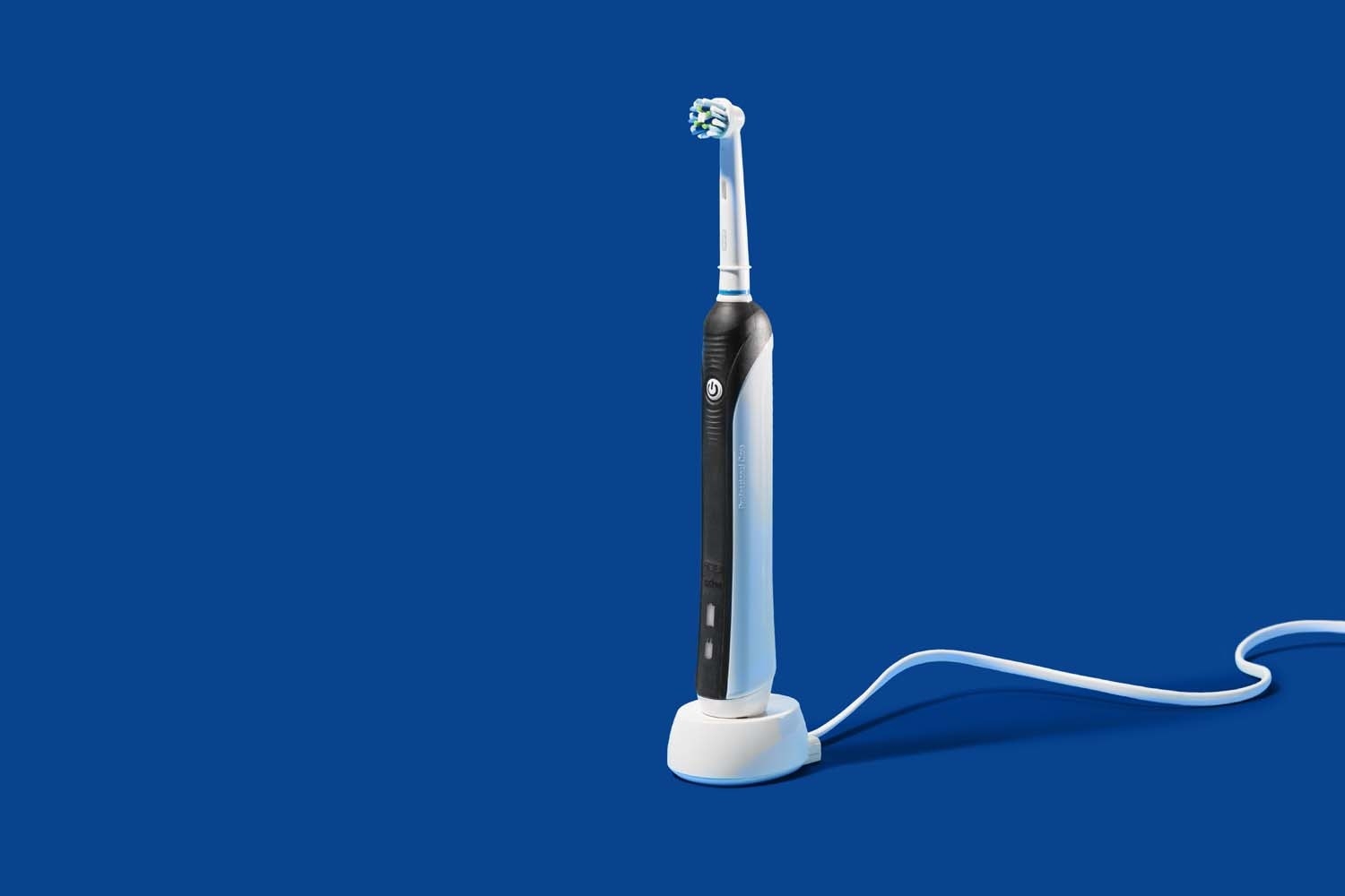 black and white electric toothbrush on charging stand