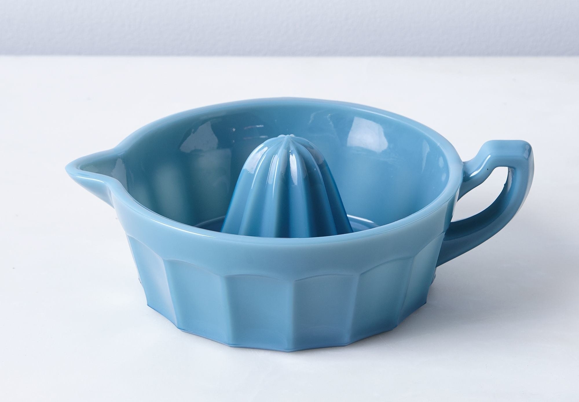 The juicer with a handle and spout in blue