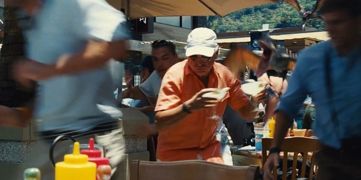 Jimmy Buffett running with margaritas in each hand