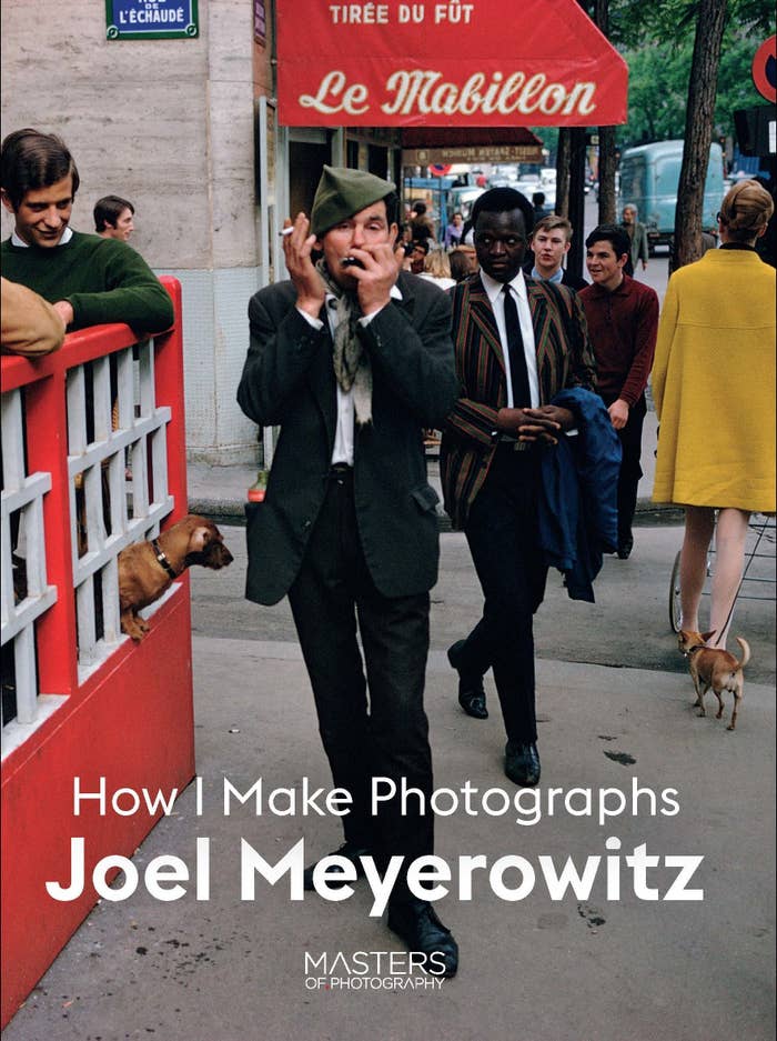 The book cover for &quot;How I Make Photographs&quot; by Joel Meyerowitz shows a man playing a harmonica and smoking a cigarette on the sidewalk while other pedestrians stare at him