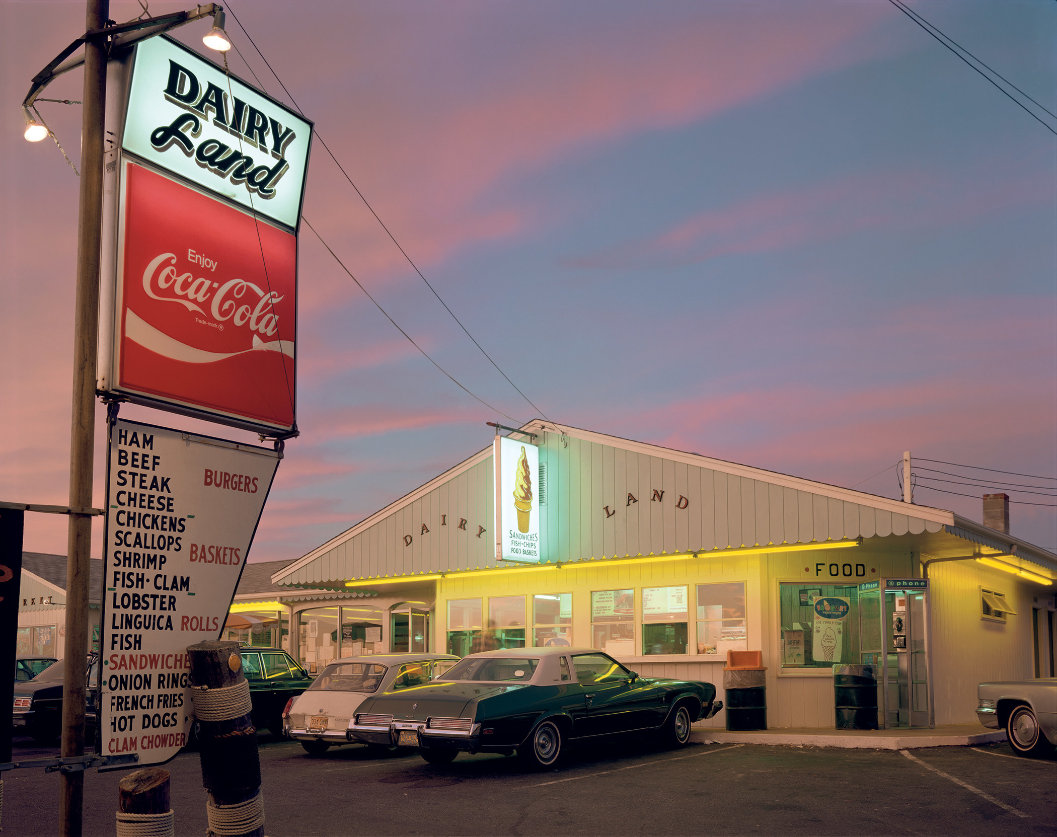 The parking lot of a fast-food restaurant at dusk