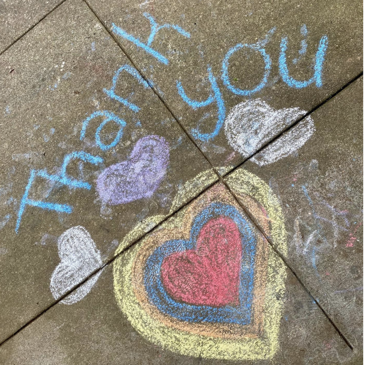 Reviewer image of a sidewalk decorated with a thank you message 