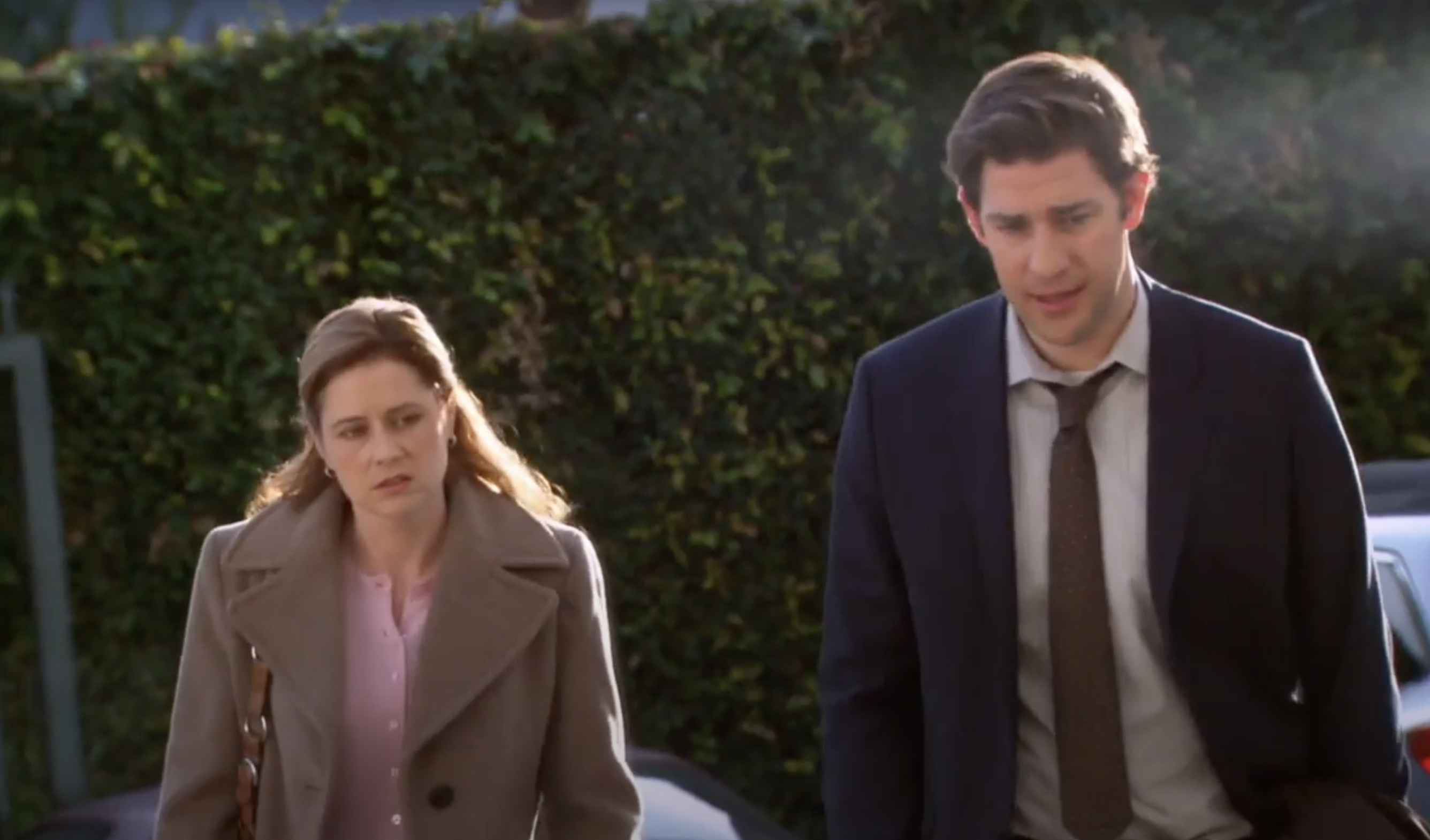 Jim and Pam walking together with annoyed expressions on their faces