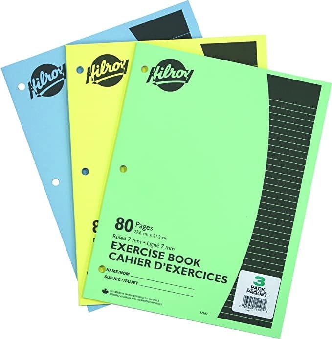 Three exercise books lay on top of each other that are three-hole punched