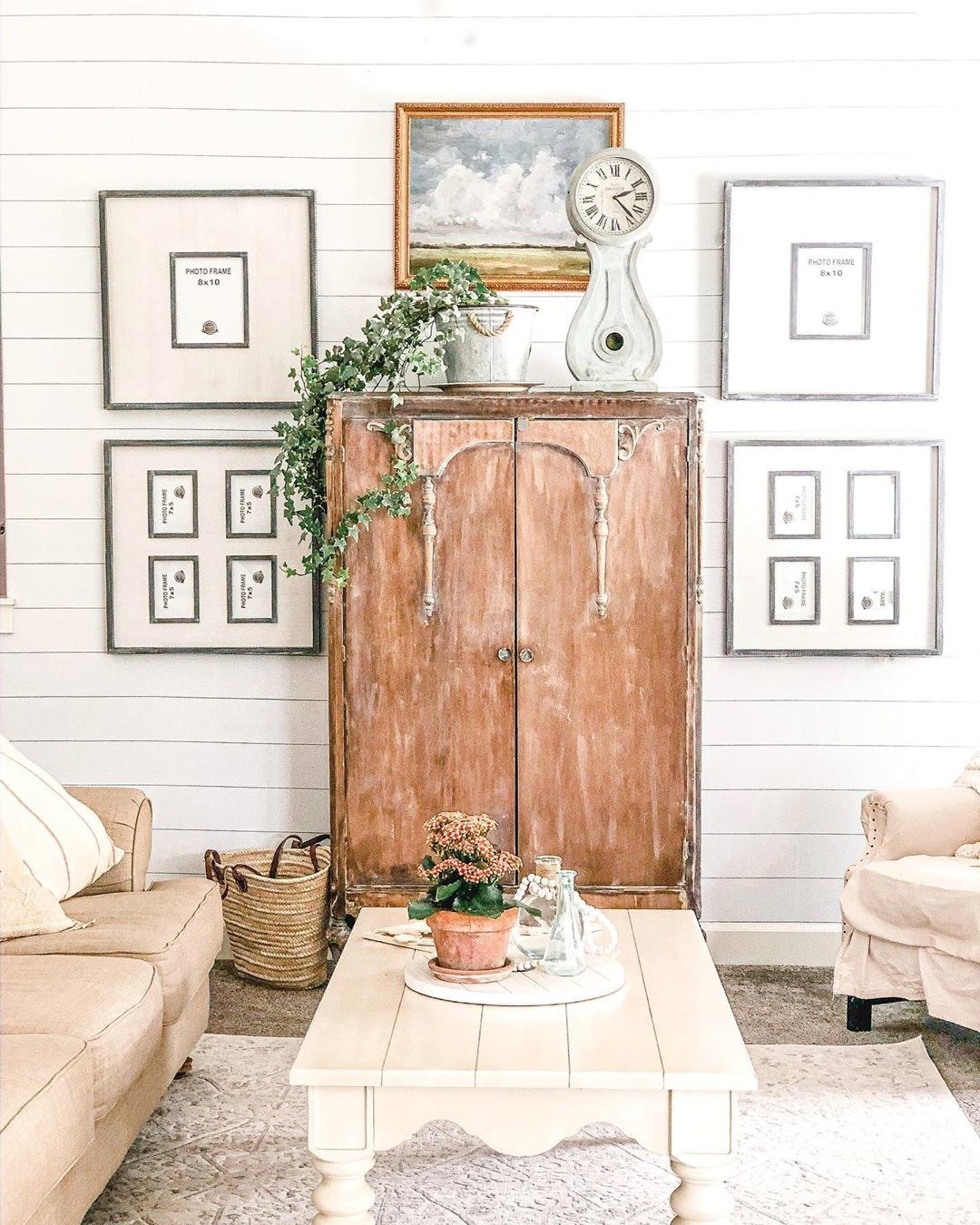 A farmhouse-styled living room uses a wooden armoire as the focal point