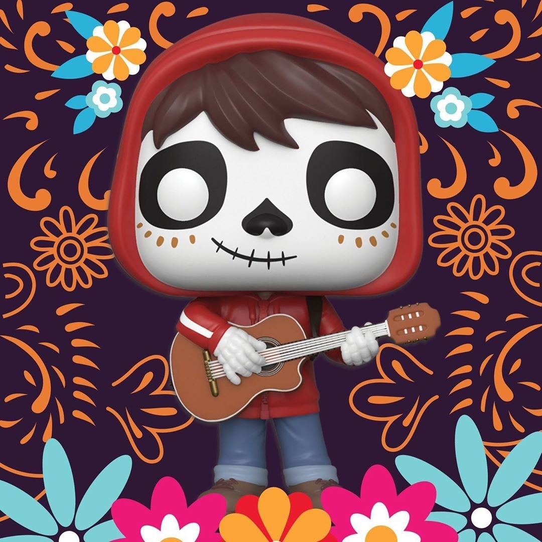 a tiny figure of miguel holding his guitar