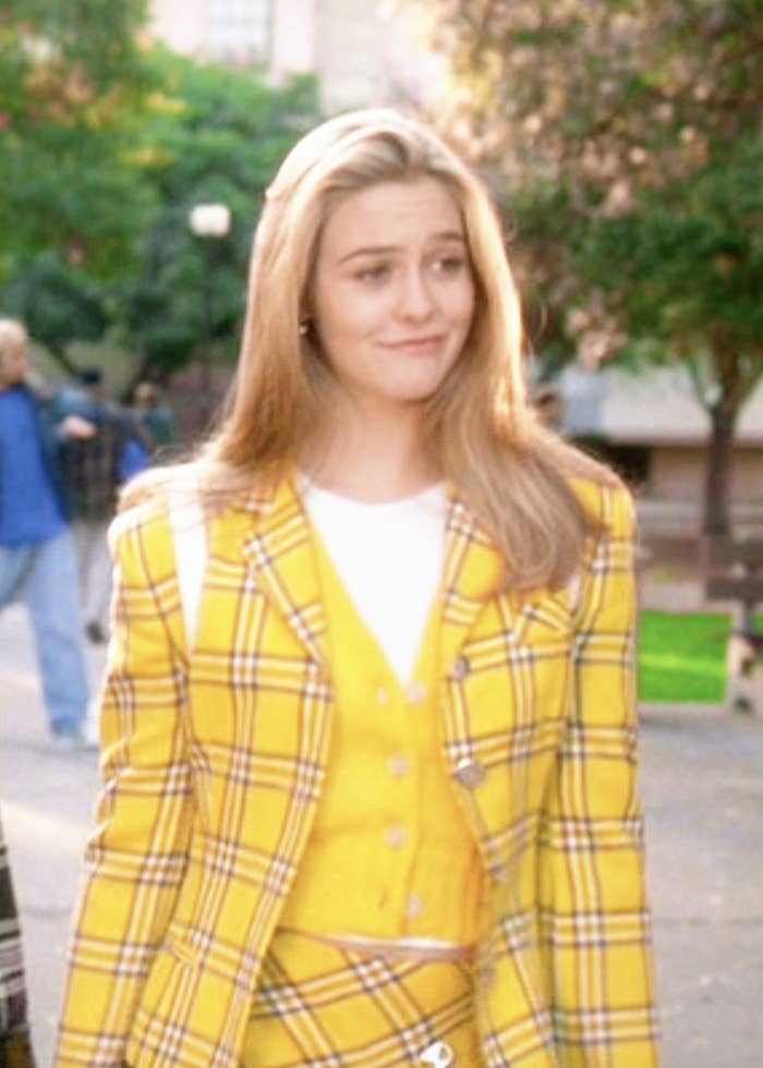 Cher wearing a plaid blazer and matching skirt with a vest
