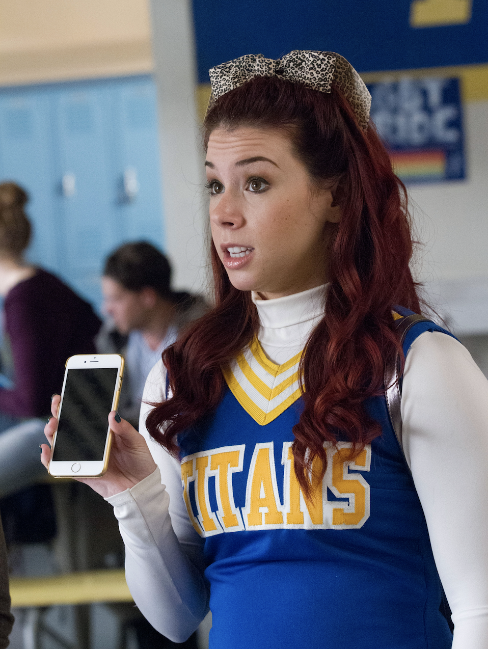 Tamara wearing a cheerleading uniform with a ribbon in her hair