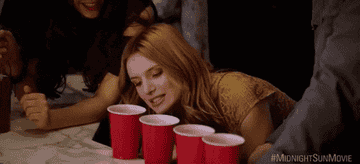 Kate playing flip cup at a party. 