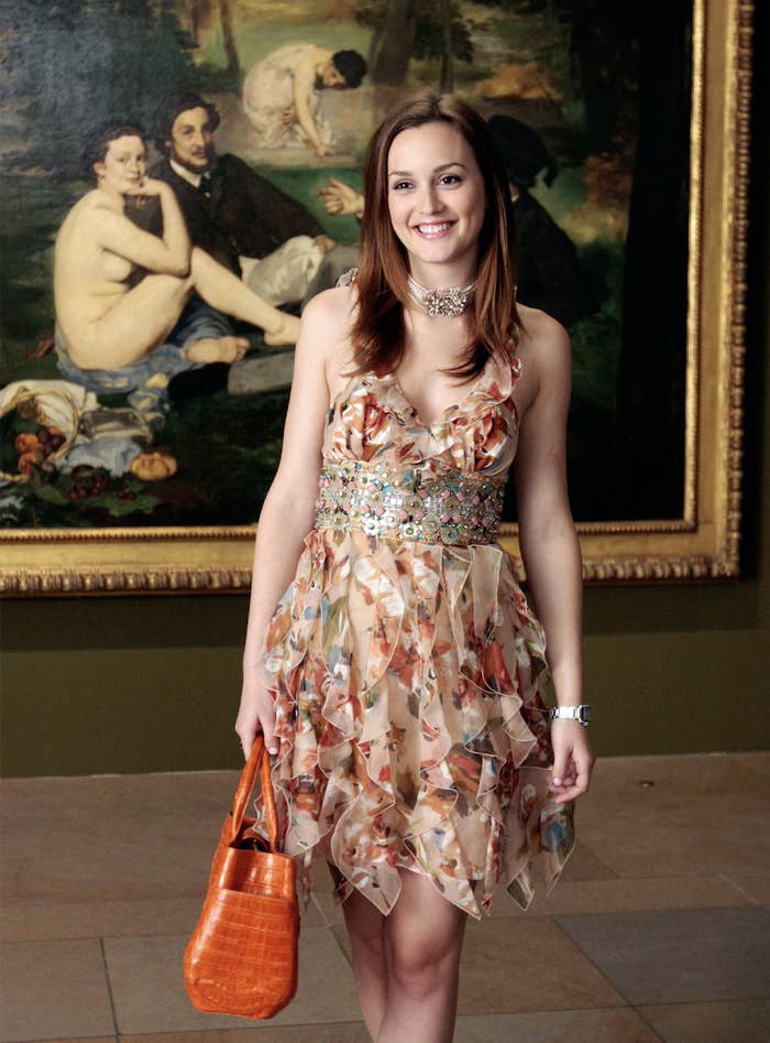 Blair wearing a ruffed floral dress with stones and jewels around her waist