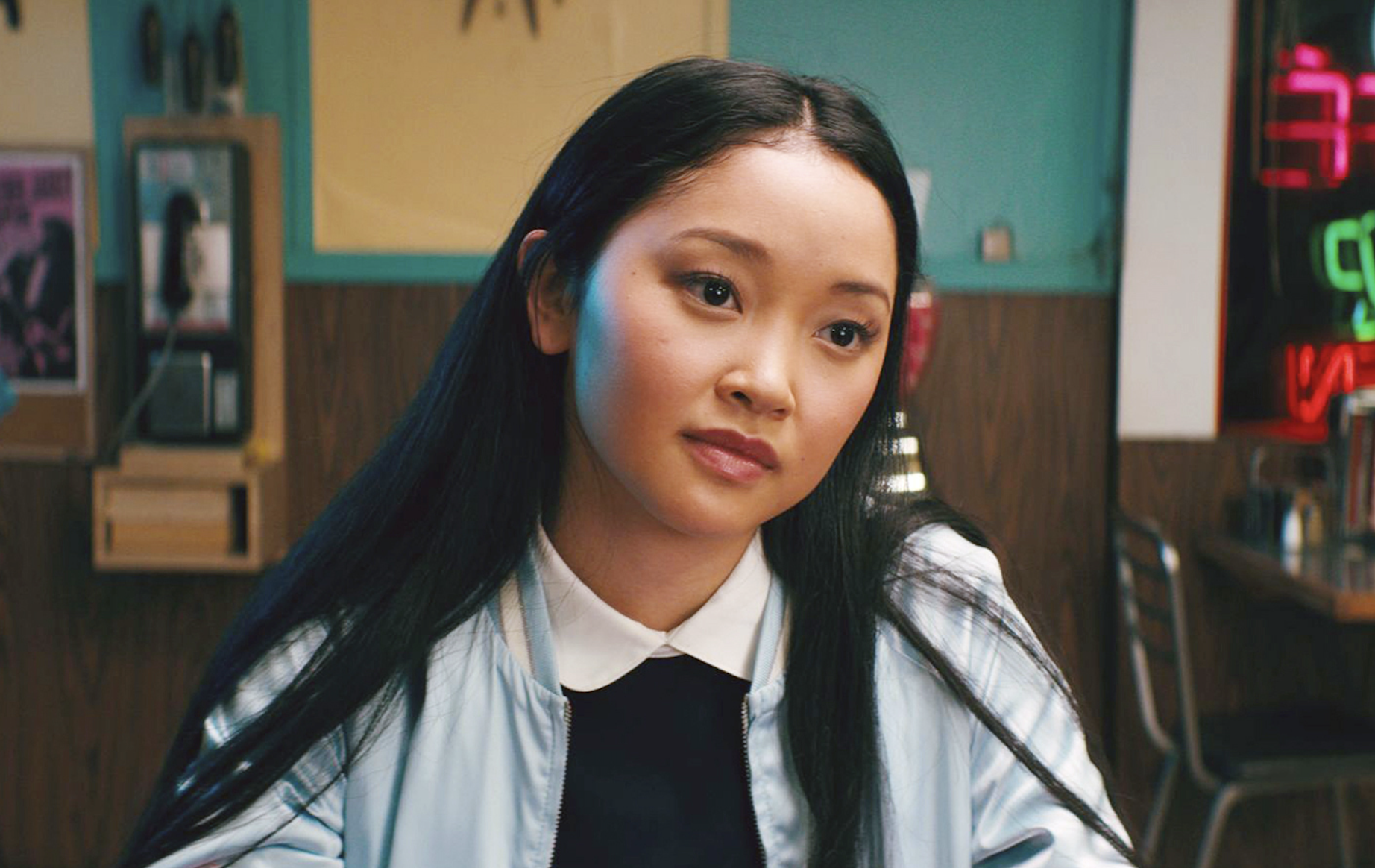 Lara Jean wearing a collared shirt with a pastel sweater