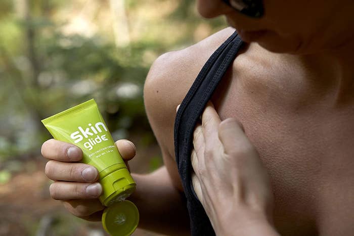 A person applying lotion to their shoulder