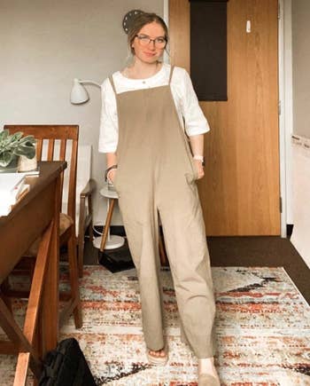 reviewer in tan linen overalls
