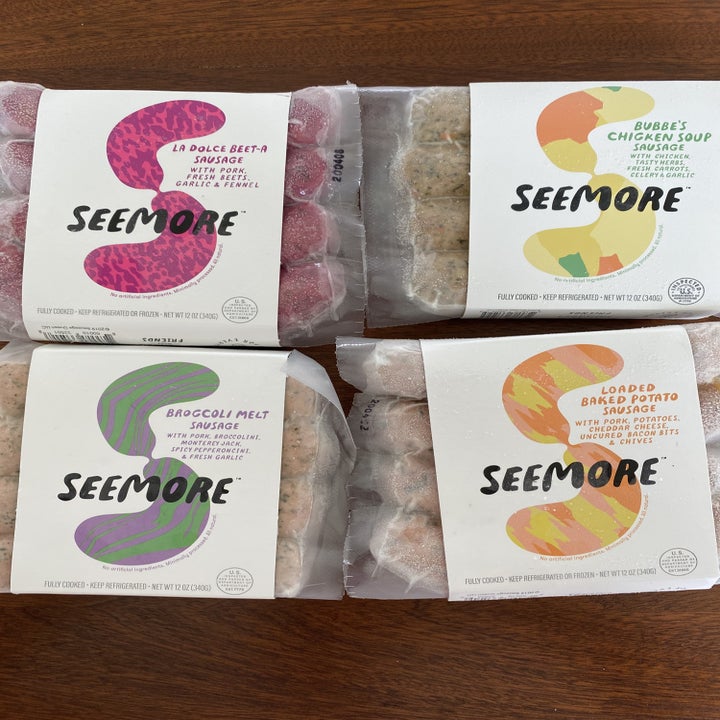 A four-pack of Seemore's sausages on a wooden tabletop.