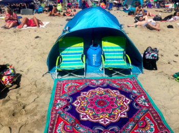 Reviewer uses same beach chairs and a blue tent to create a shady spot at a beach