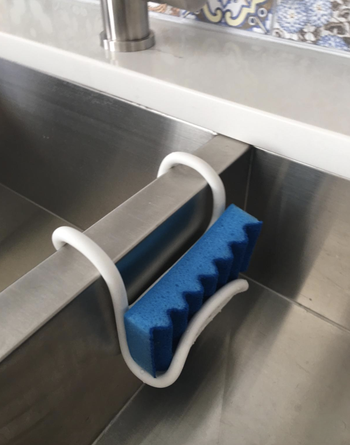 reviewer photo of white holder hanging in sink 