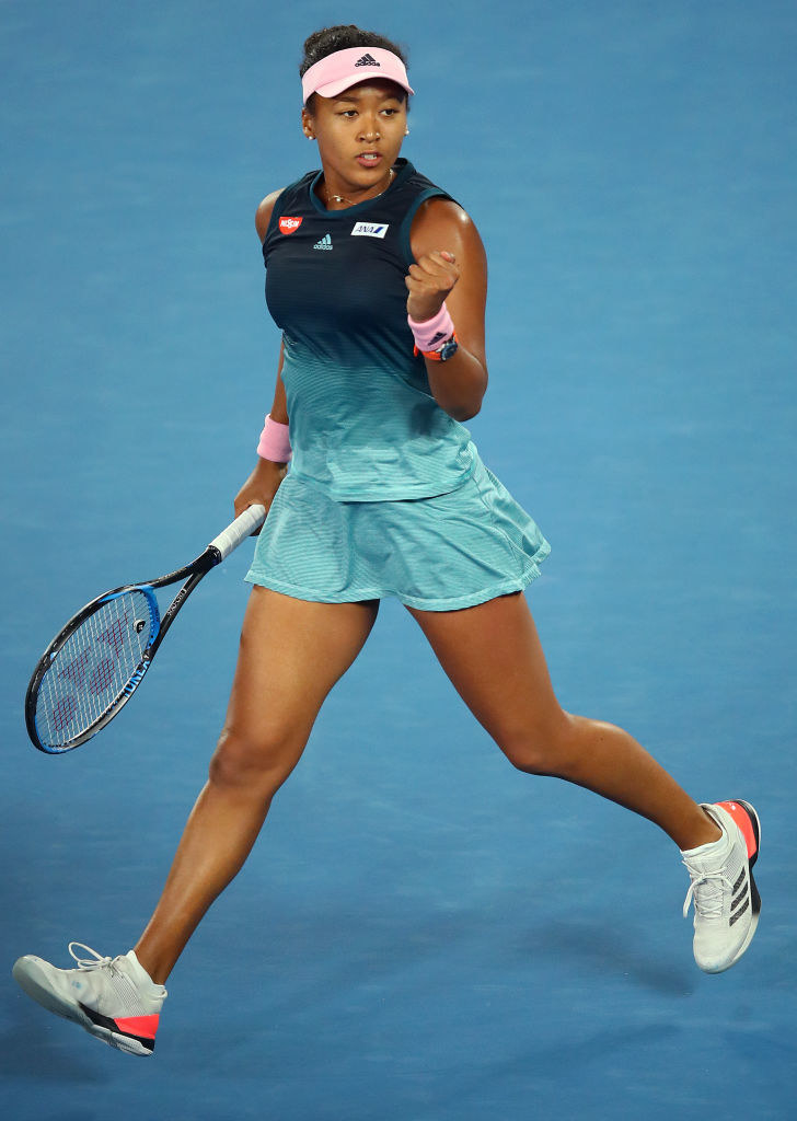 Naomi Osaka celebrating during a tennis match.