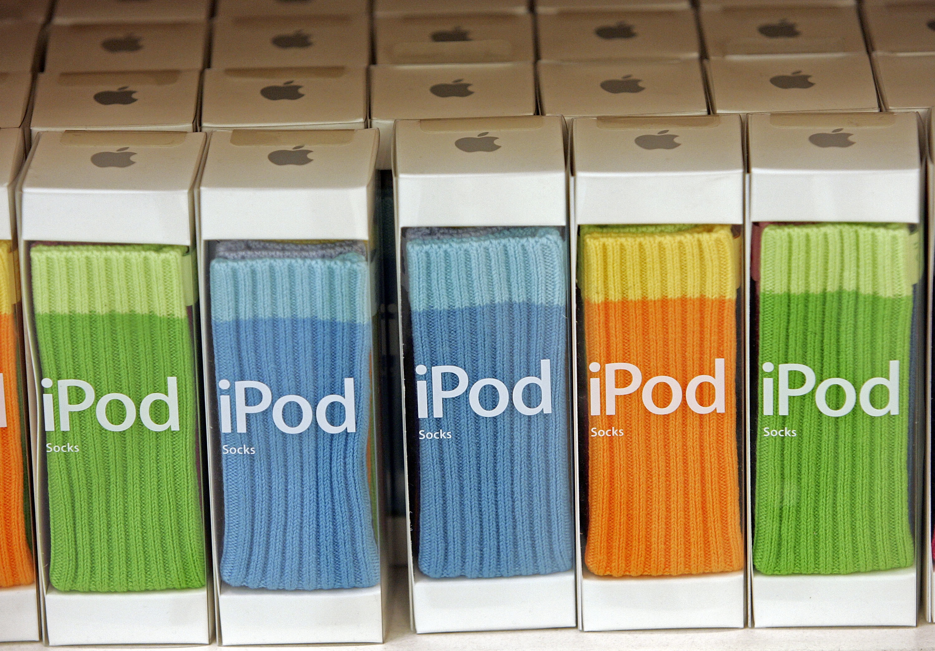 A row of iPod Socks on the shelf of an Apple Store.