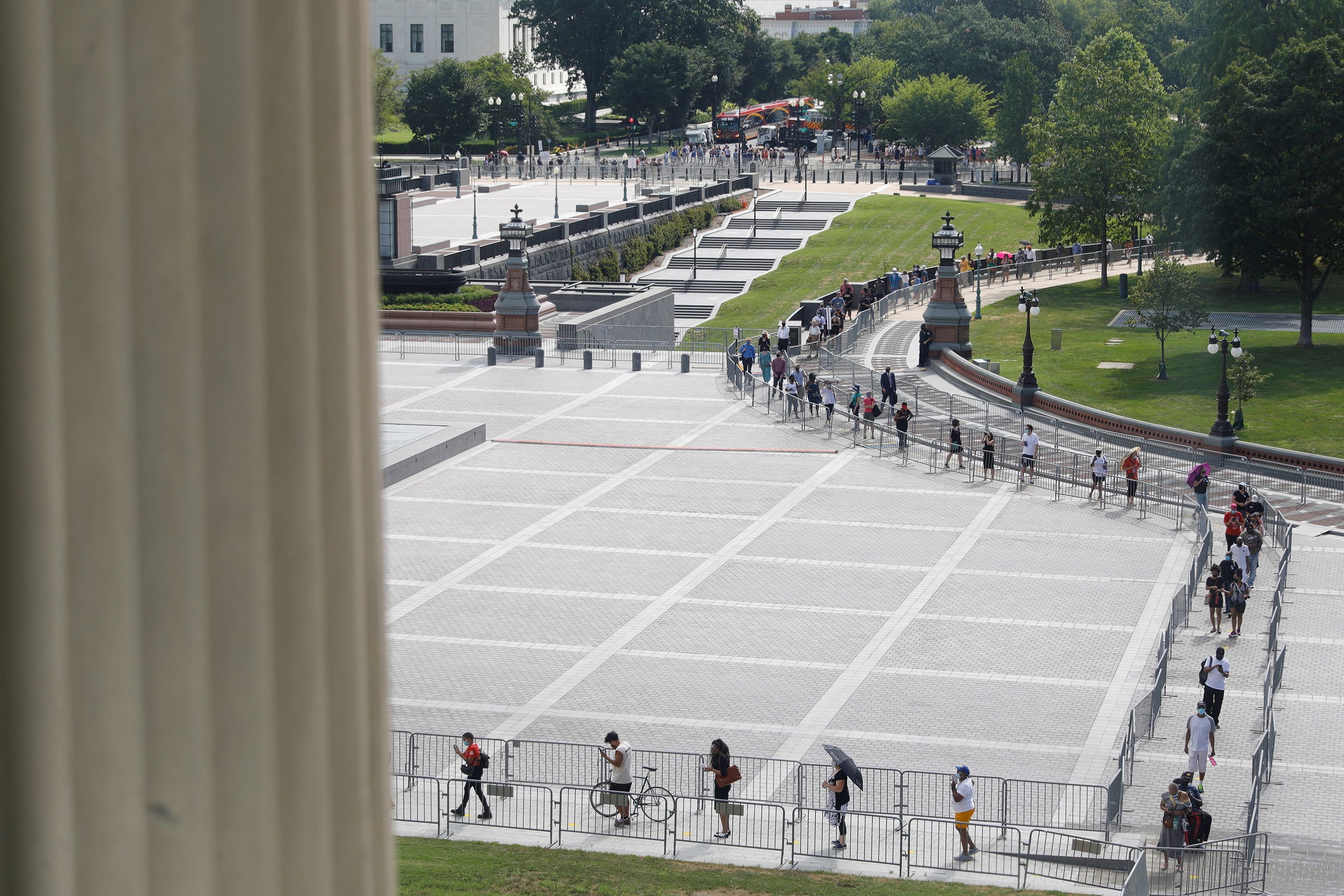 Visitors form a socially distanced queue outside the Capitol