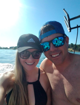 Couple wears black polarized glasses while relaxing at the beach