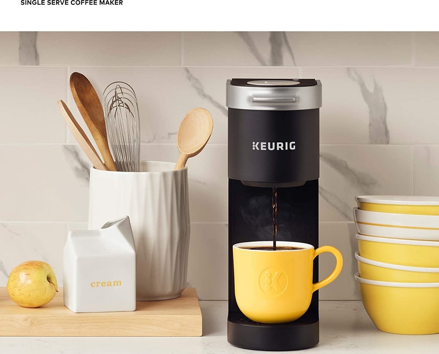 The slim machine dispensing coffee into a mug
