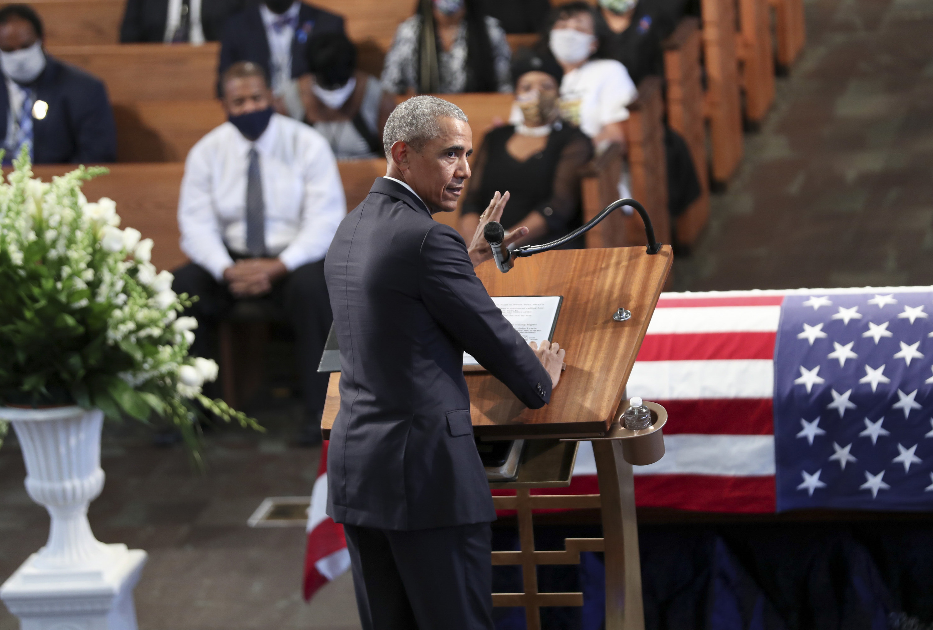 Obama at the lectern in front of the flag-draped coffin of John Lewis