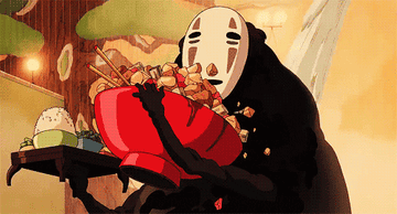 No-Face from Spirited Away messily gobbling up a bowl of food