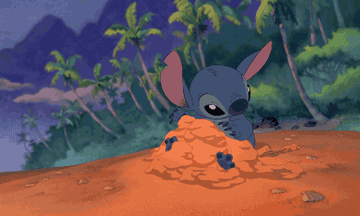 Stitch from &quot;Lilo &amp;amp; Stitch&quot; turning himself into a sand sculpture