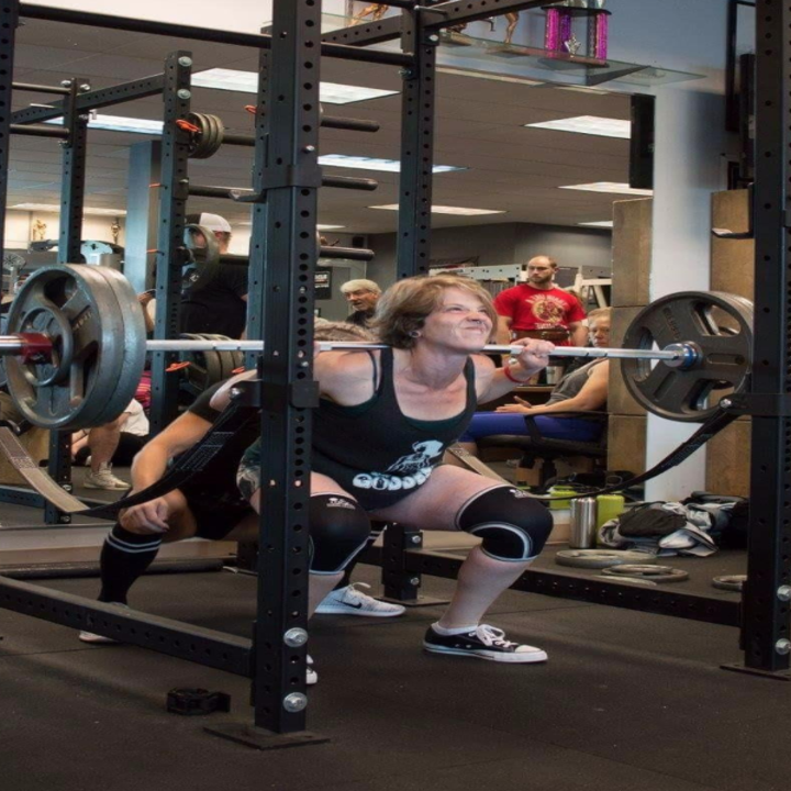 A reviewer wearing the knee sleeves as they squat with a barbell
