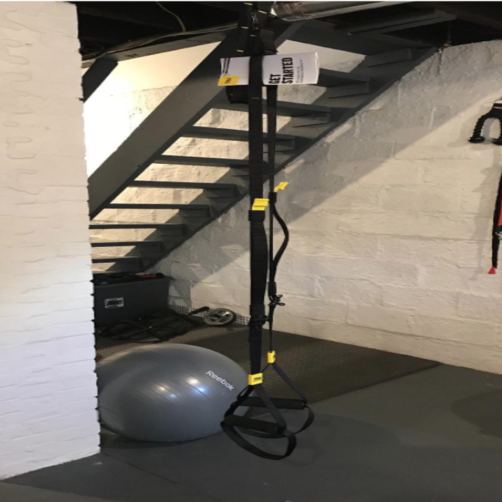 The TRX straps hang in a reviewer's basement