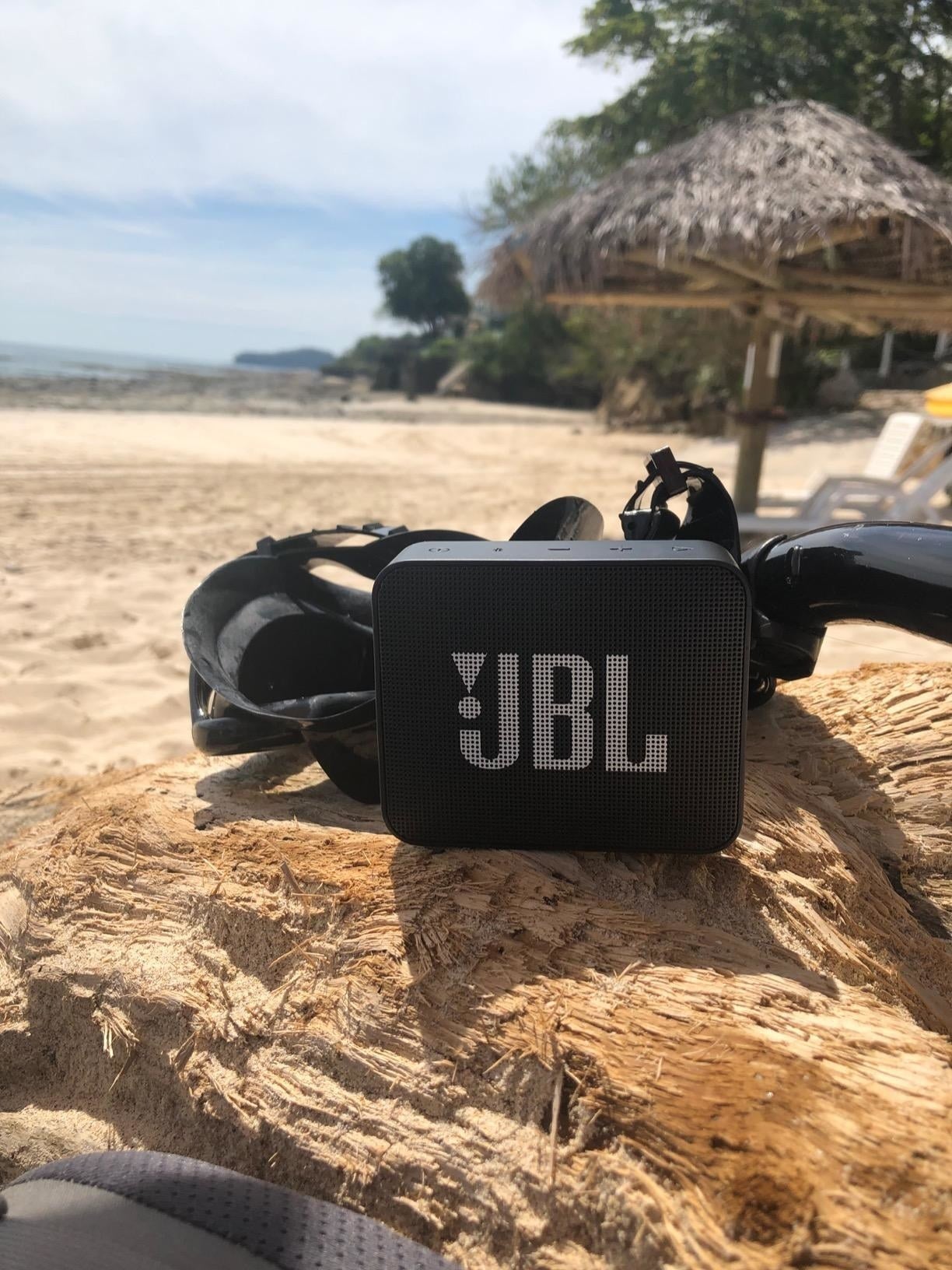 A black rectangular Bluetooth speaker with the JBL logo in white 