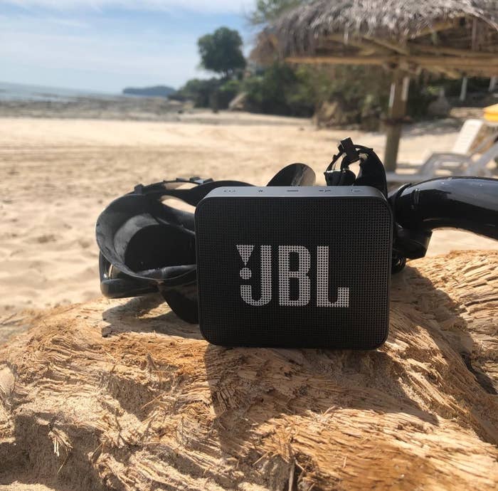 A black rectangular Bluetooth speaker with the JBL logo in white 