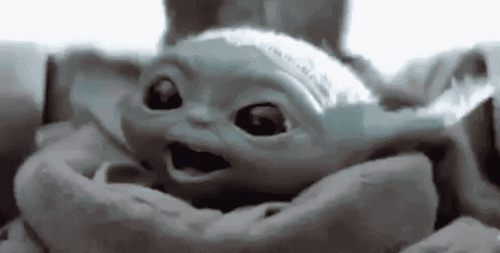 a gif of baby yoda flying and excited