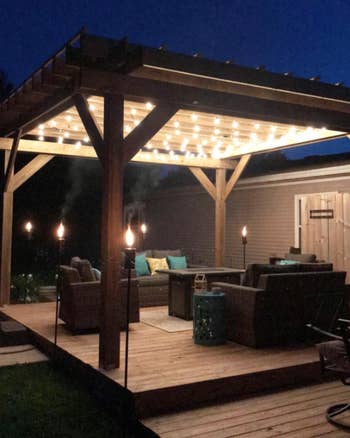 A reviewer photo of the lights hanging over a patio awning 