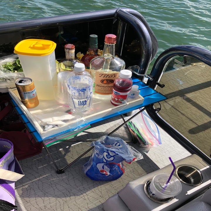Blue table near water filled with bottles 