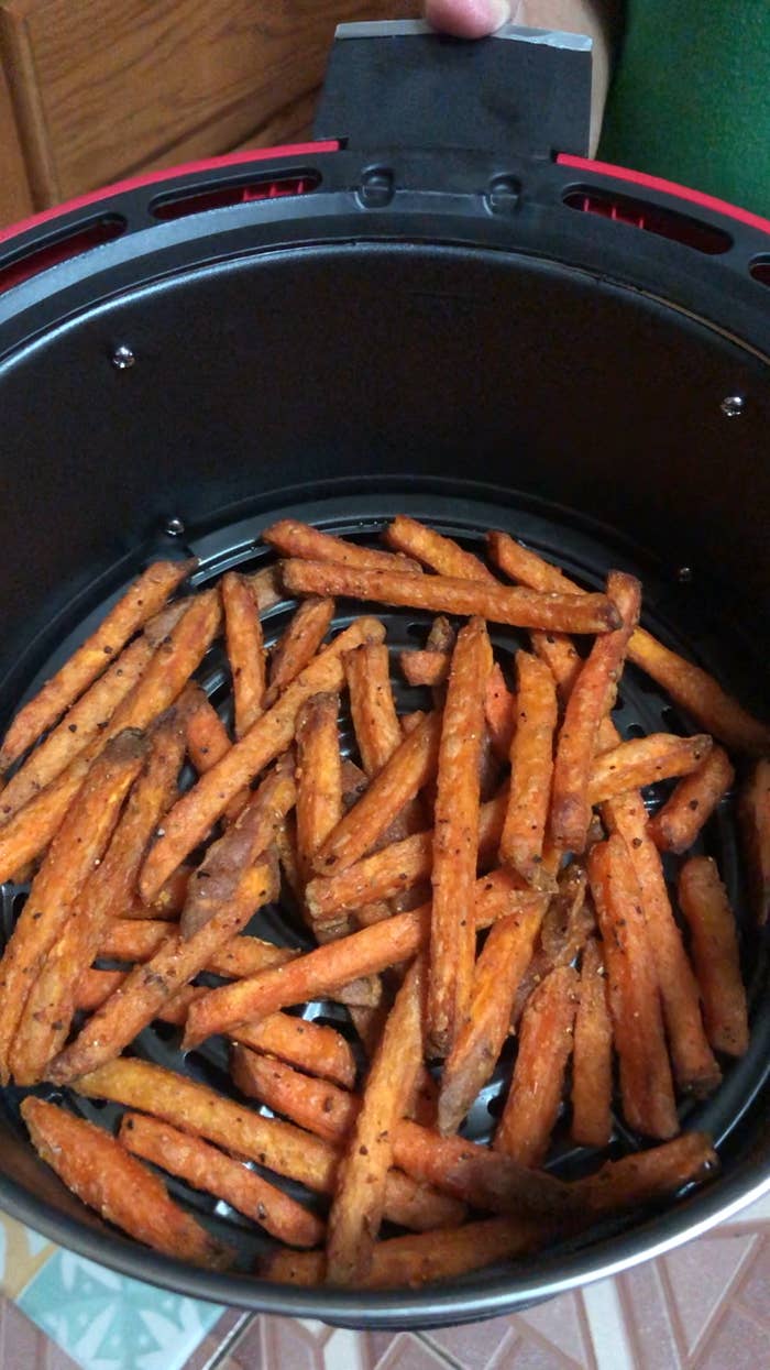 Fully cooked sweet potato fries in the chamber of the air fryer