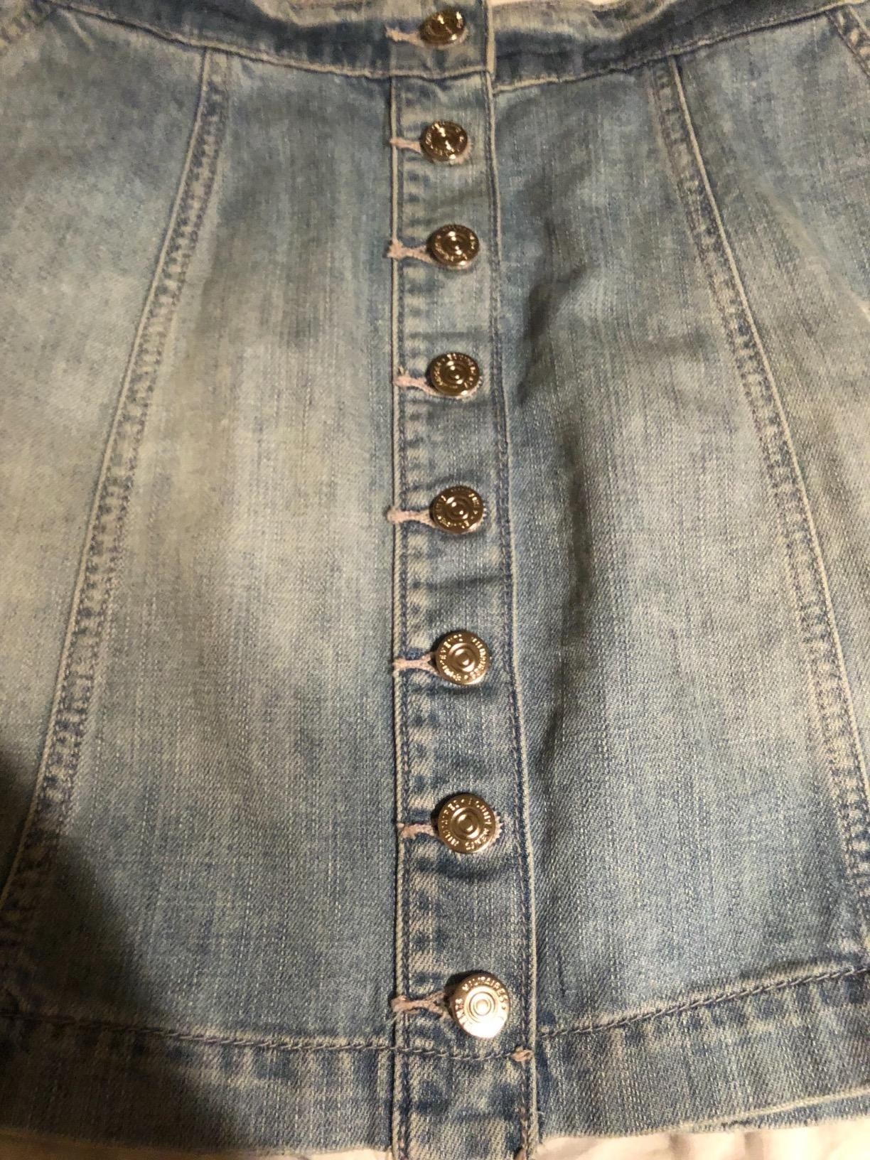 Reviewer photo of a denim skirt with buttons down the front 