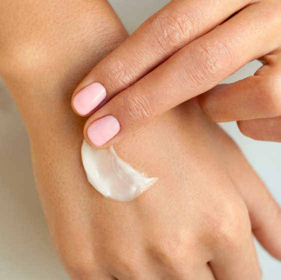 A model&#x27;s hand with the cream on it 