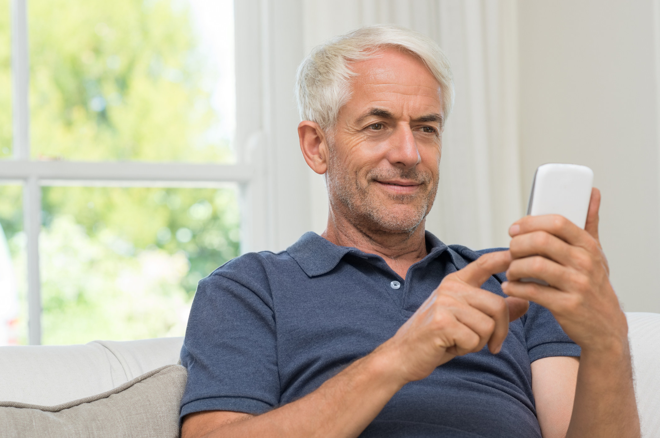 Older man looking at phone