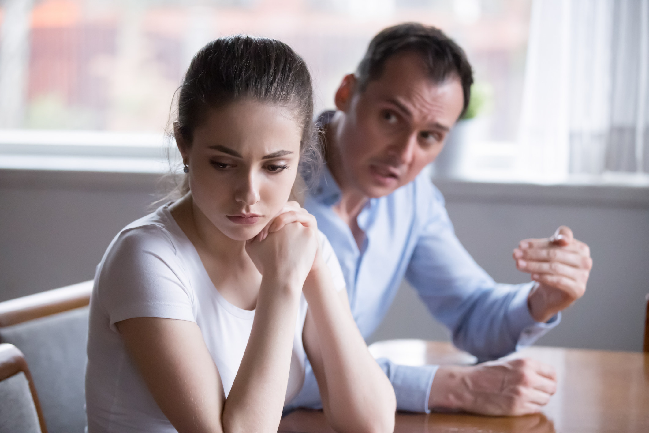 A daughter turning away from a father in anger