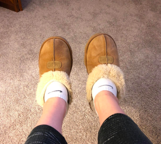 A reviewer wearing the slippers in tan