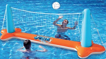 Two models play volleyball using the net in a pool