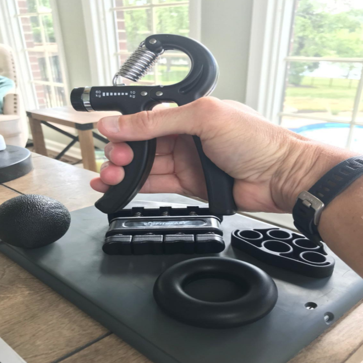 A reviewer holds the hand gripper